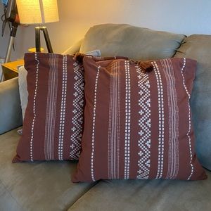 two burgundy tribal pillows
